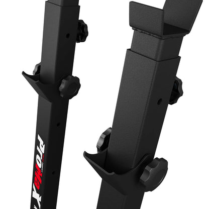 Detailed view of squat rack stand adjustment system and safety hooks